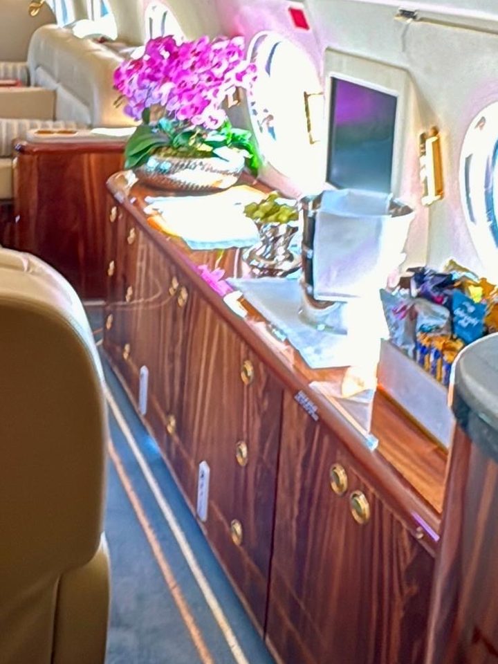 Veneer credenza in a business jet set with orchids, fruit and snacks