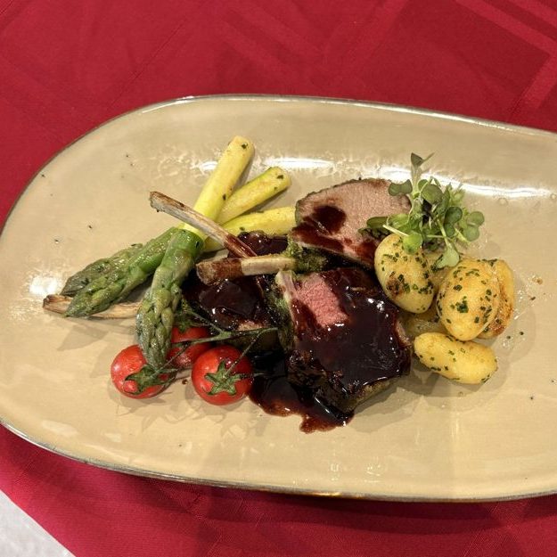 Herb-crusted rack of lamb with asparagus and potatoes